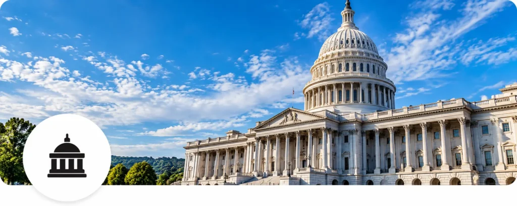 U.S. Capitol exterior with blue sky; white circular overlay in bottom-left shows a black capitol icon.